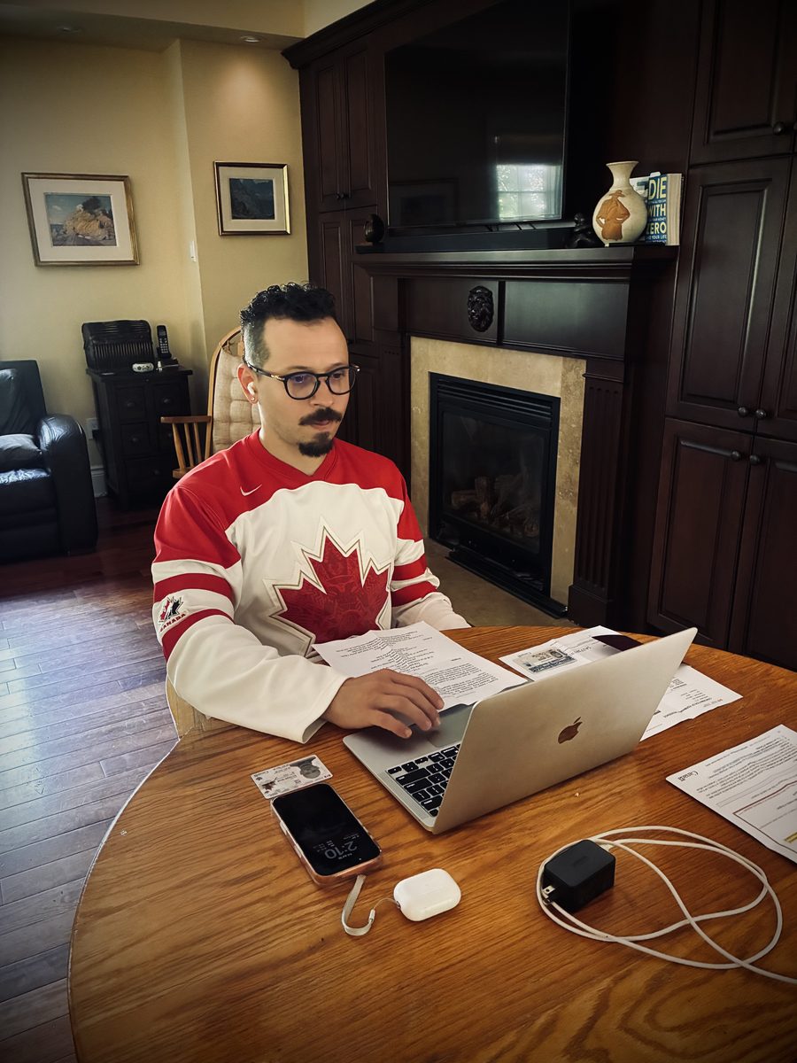 Ivan Otto, Whistler Council candidate, working on his 2026 campaign at his laptop in a Team Canada jersey